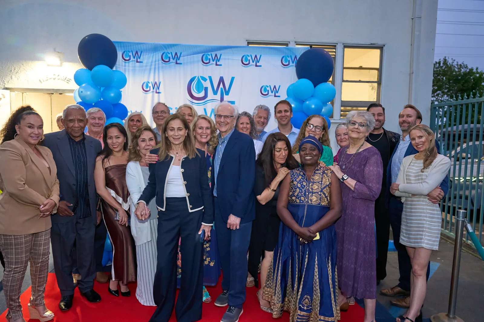 Guests gathered in front of the Give Water Give Life backdrop at the 2026 Gala.